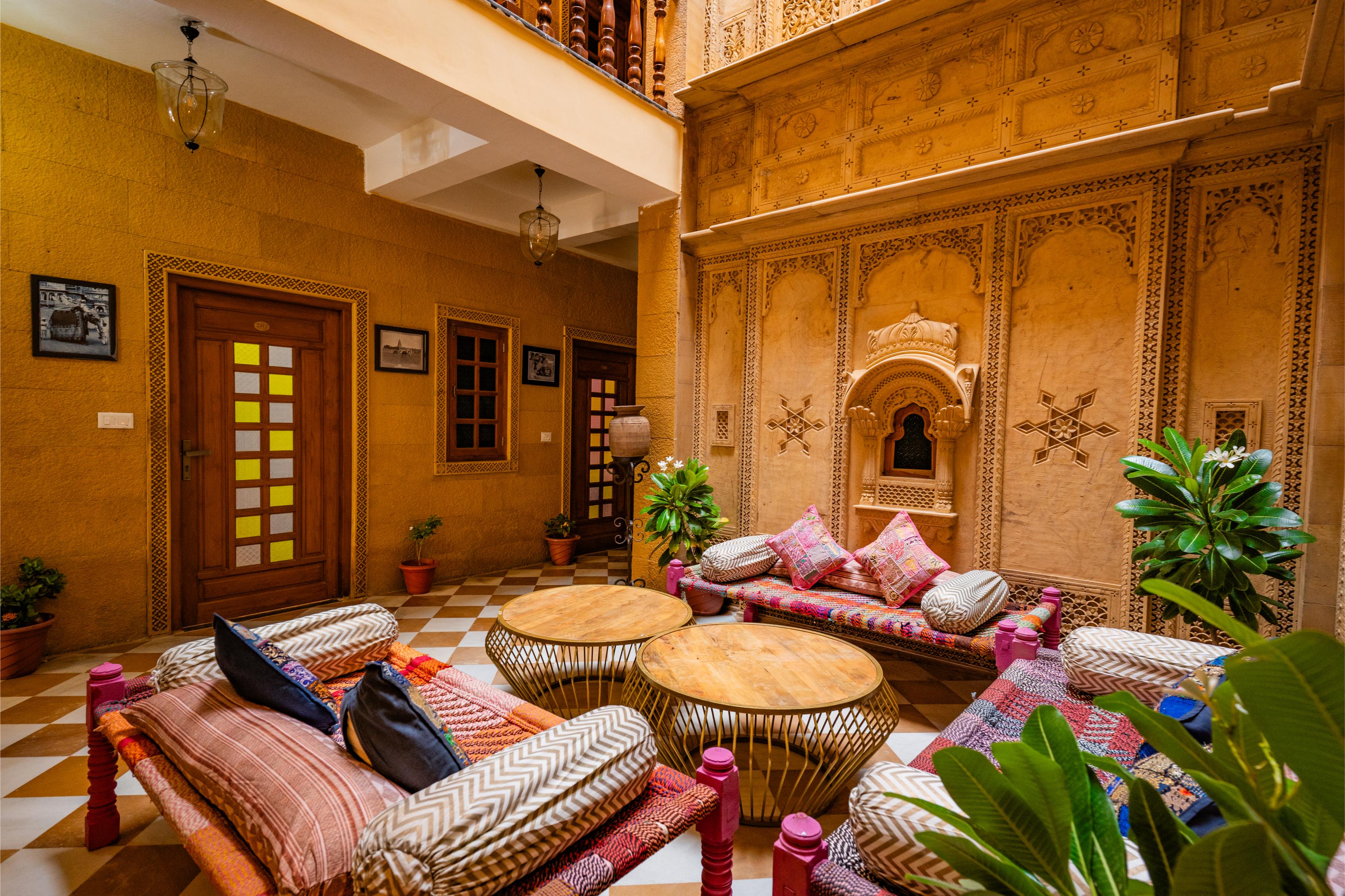 Courtyard seating and dining ambiance with carved sandstone walls